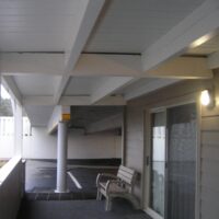 Underside of the walkway showing the wood beams and decking above the parking level