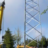 Crane beside the lower sections of the new tower during erection