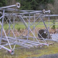 Galvanized steel tower sections laid out on the ground before erection