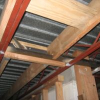 New wood framing under the existing steel joists and metal roof deck