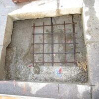 Reinforcing steel set in a new footing cut into the loading area paving