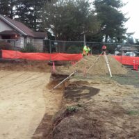 Fenced construction site with the graded pad and survey equipment