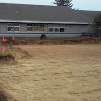 Graded building pad for the new Options Counseling office in Florence, with the existing building behind