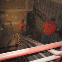 Shotcrete being placed on a new reinforced wall inside the building